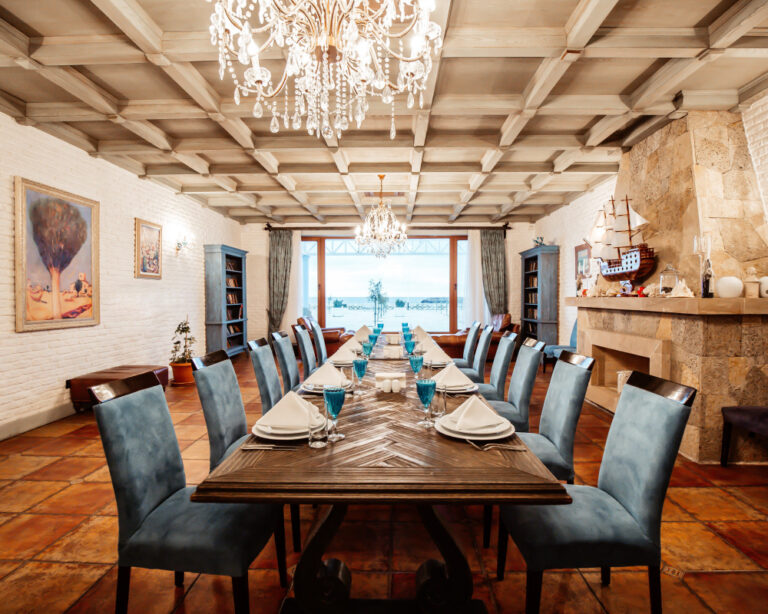 restaurant-table-12-persons-with-blue-chairs-fireplace-white-brick-walls-wide-window